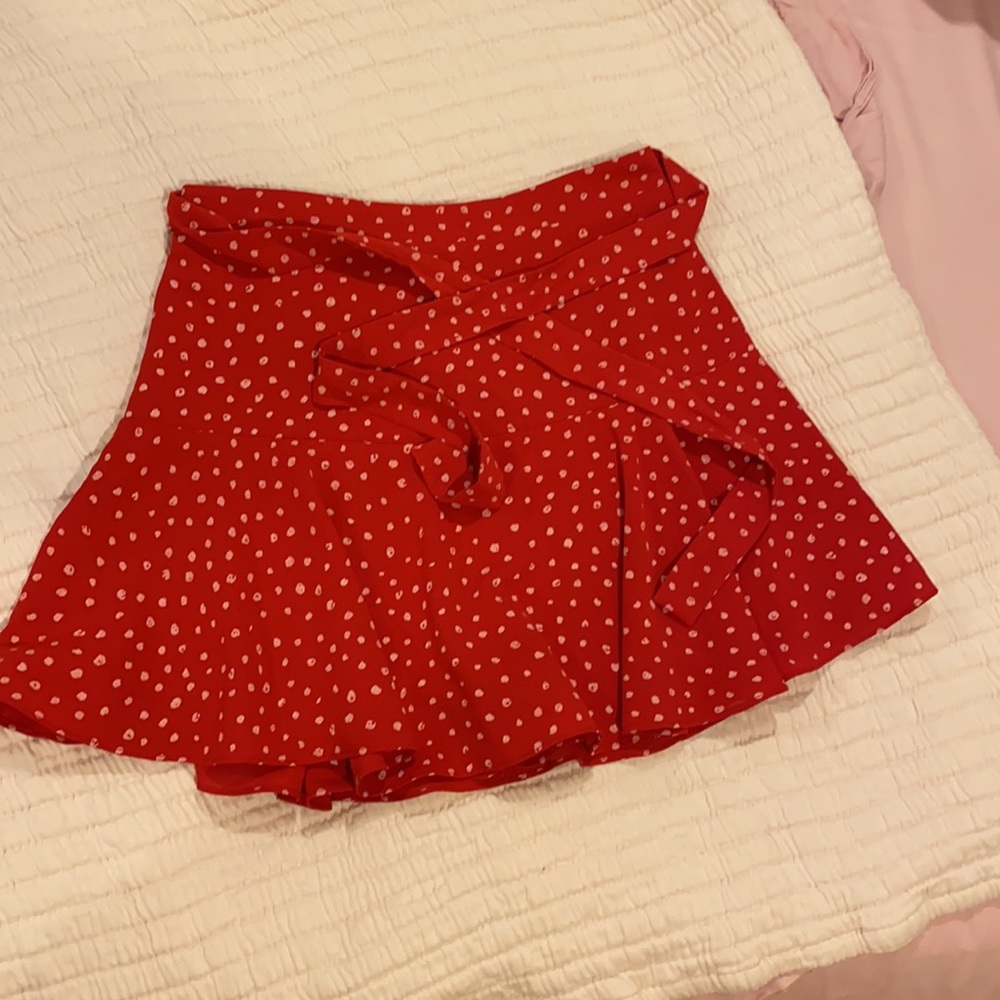 Red skort/skirt. Ties in front or back.